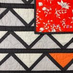 Grey, Black and orange fabric that make a Cafe Tiles Quilt and Backing