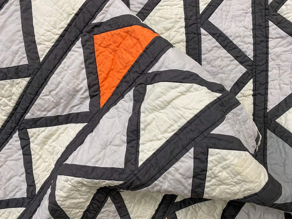 grey, black, and orange fabric triangles Cafe Tiles Quilt folded