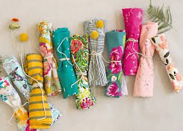 bright colored fabrics rolled and tied with string