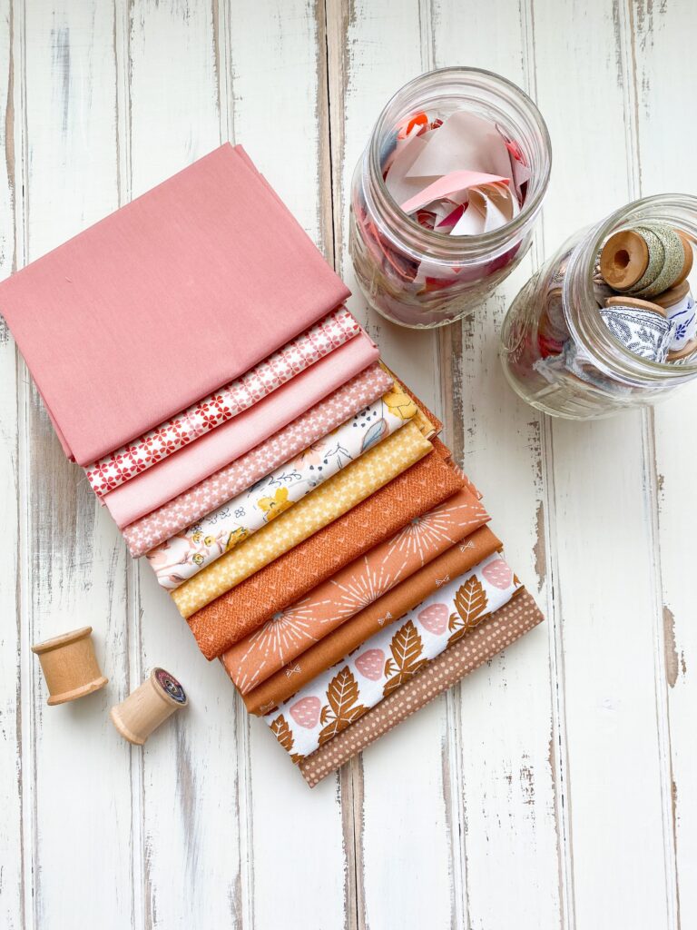 Quilting fabrics that are pastel on a wooden table