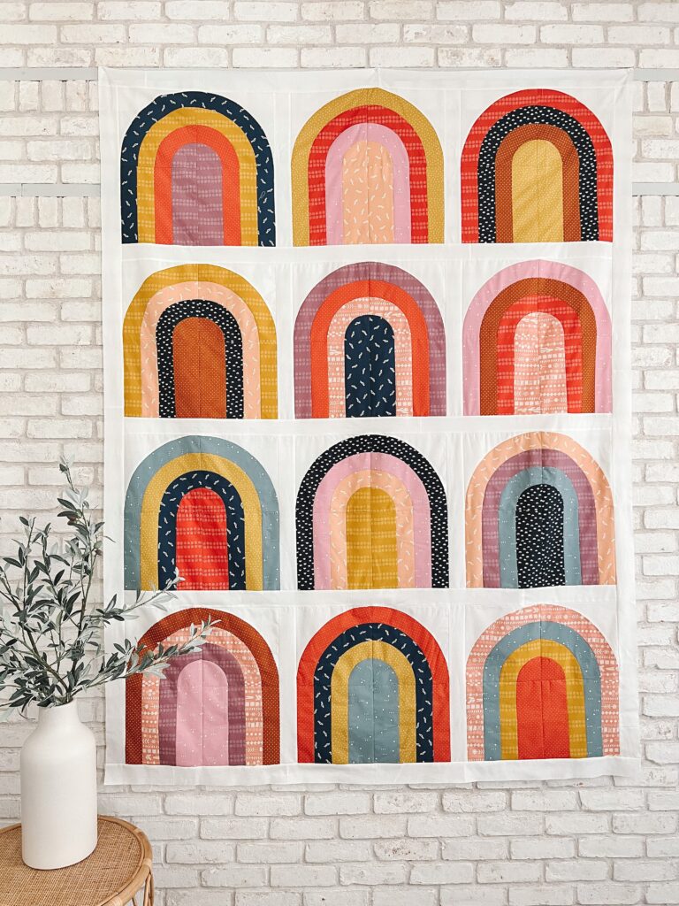 Jewell toned fabrics making a rainbow quilt