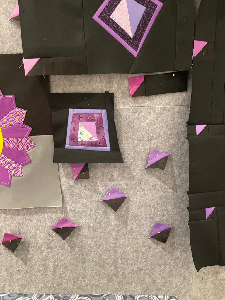 black fabric with various shades of purple shapes