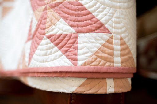 Curved long arm quilting on peach and white fabrics