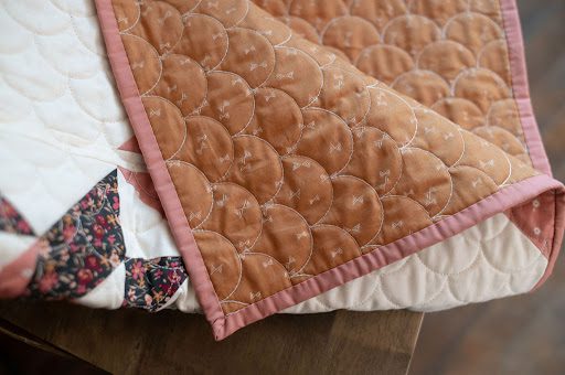 Example of long arm quilting on peach and pink quilt