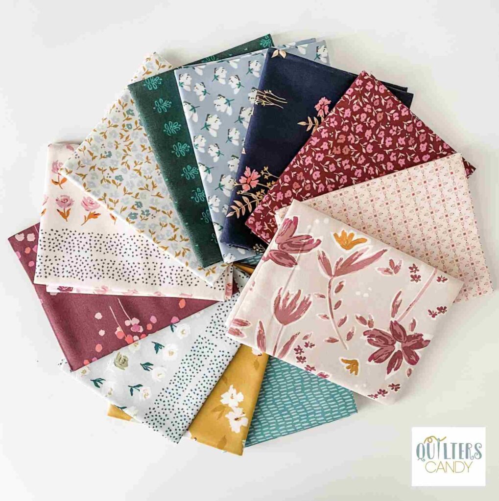 a bundle of mayfair fabric with the quilters candy logo in the bottom right corner