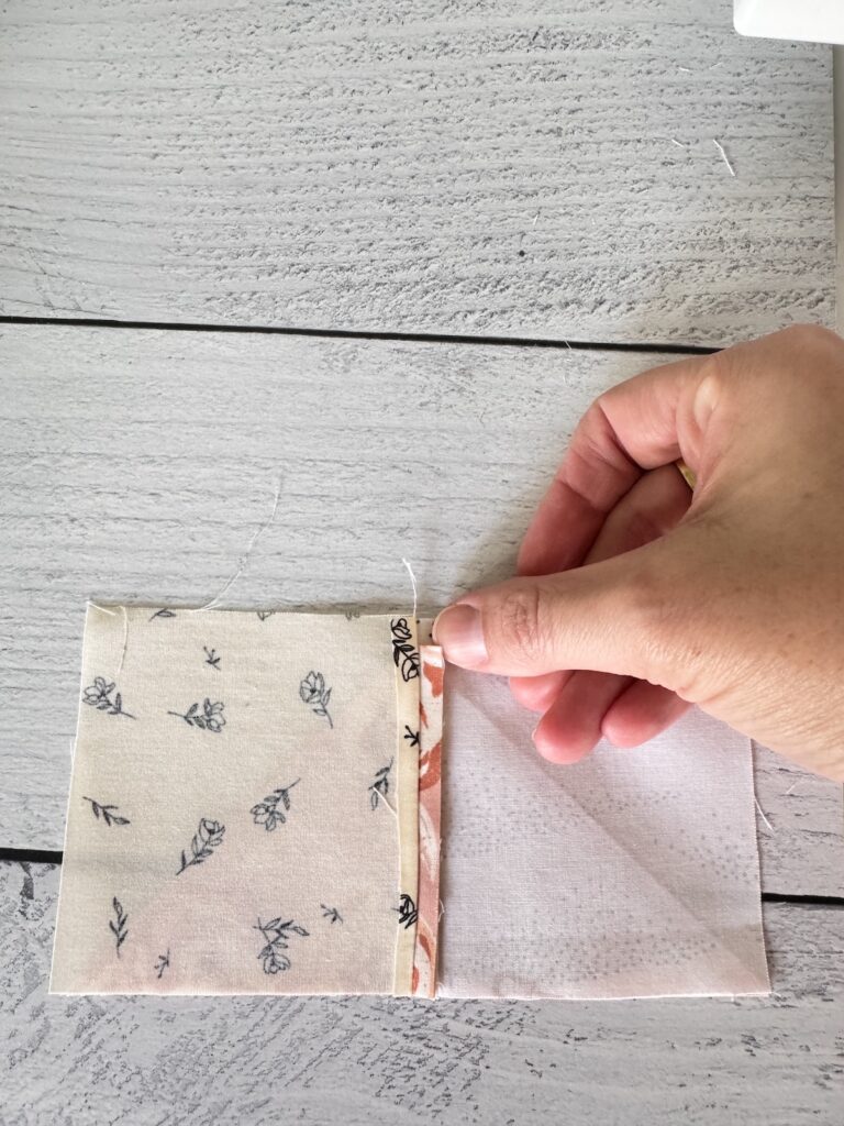 Back side of a Front Porch quilt block highlighting the ¼" seam allowance with the triangle point visible for accurate alignment during assembly.