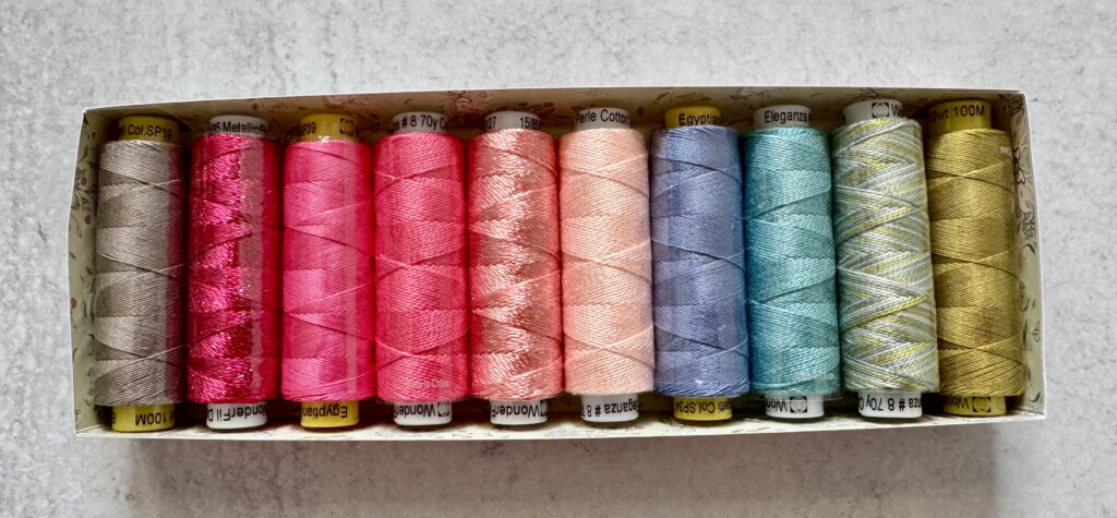 Wonderfil brand quilting thread collection in bright colors, ideal for experimenting with different thread weights in quilting.