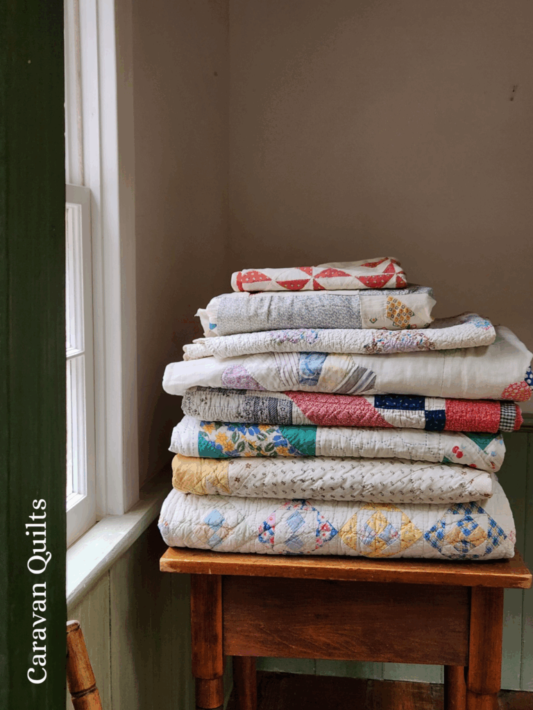 a stack of finished quilts