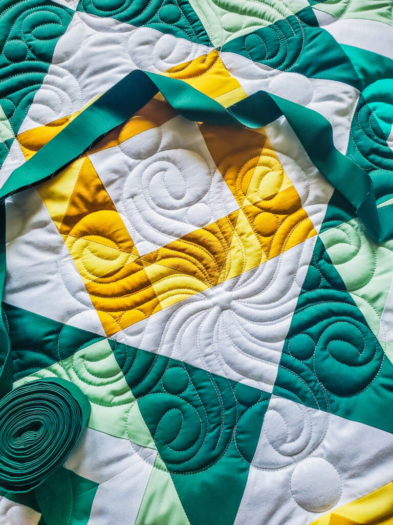 Longarm quilt showing allover pantograph quilting to demonstrate how to choose the right pantograph for a quilt top