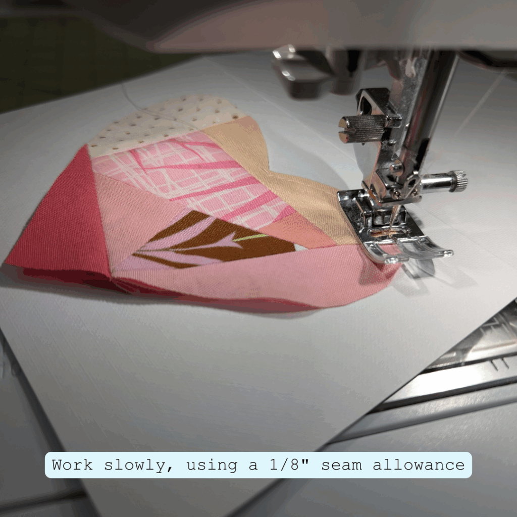 Stitching slowly around a fabric heart using a 1/8 inch seam allowance