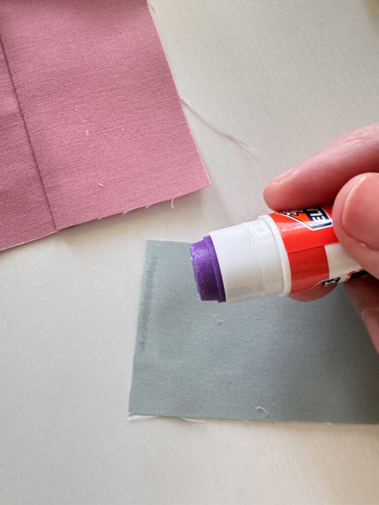 Glue pen applying a thin line of glue to fabric seam allowance before piecing