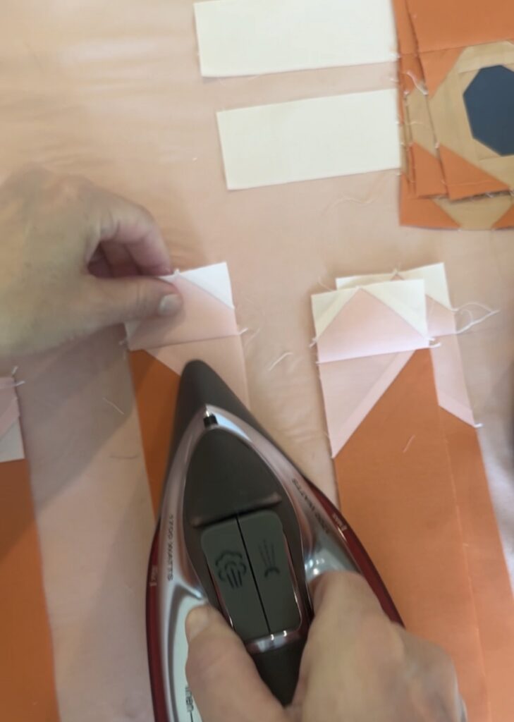 Glue basted quilt block seam pressed with an iron before sewing